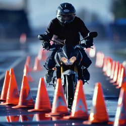 man-motorcycle-is-riding-through-traffic-cones